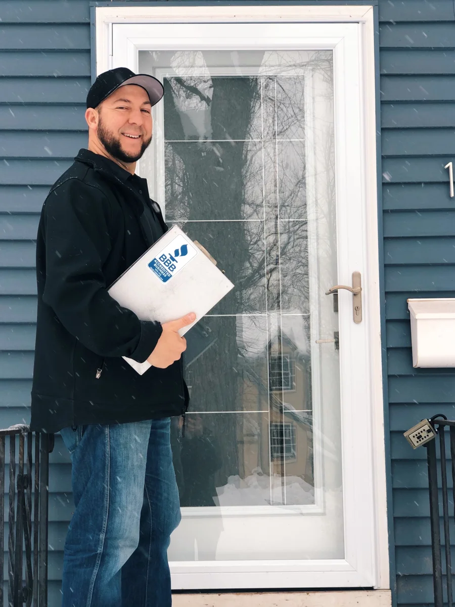 Ryan, Owner and Head Contractor, standing at a front door